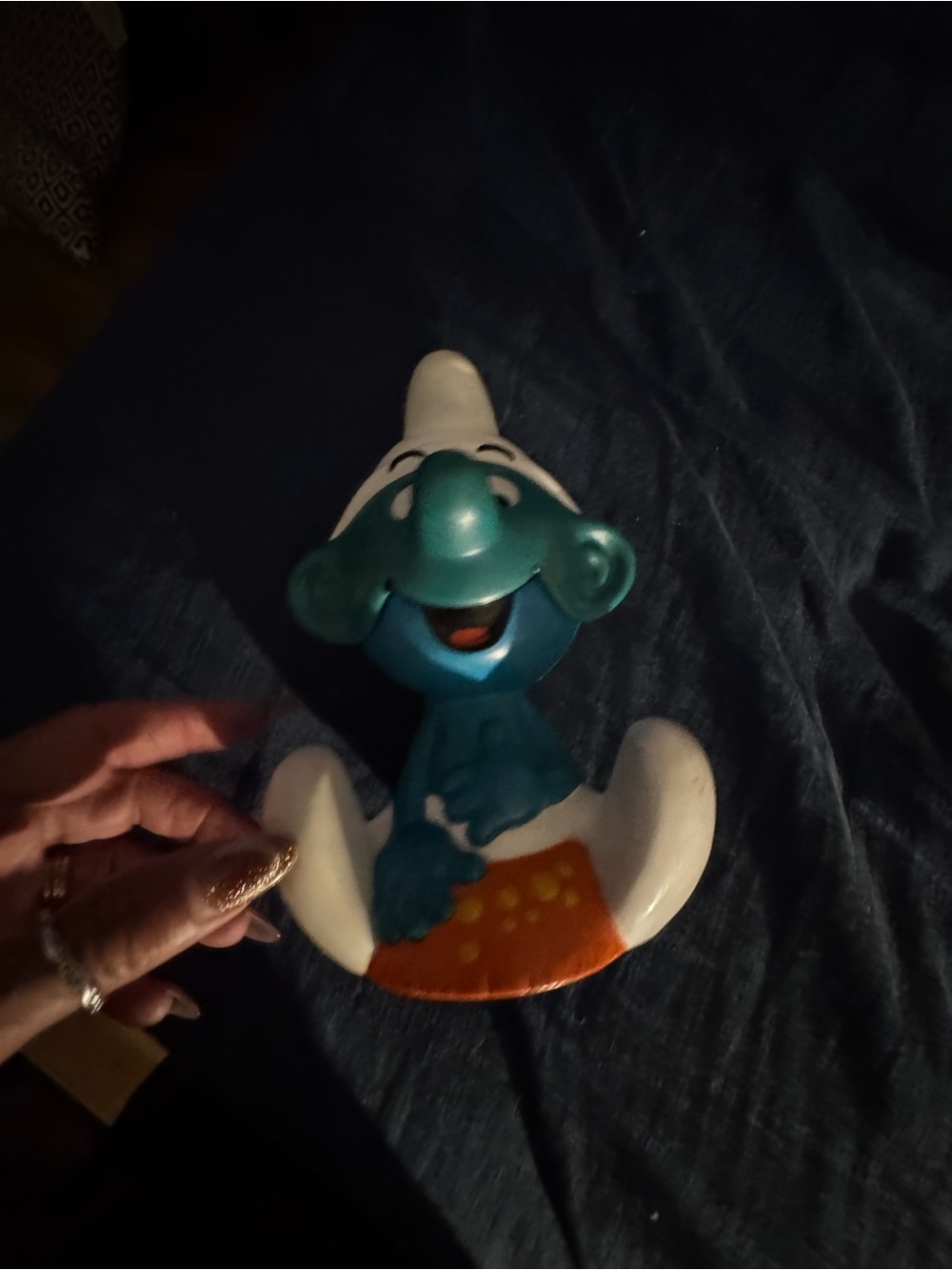 Blue Smurf Figurine in White Hat on Orange Base